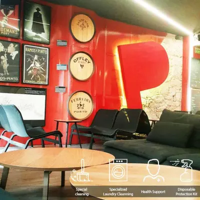 a room with clocks on the wall and a table at PILOT Design Hostel & Bar in Porto