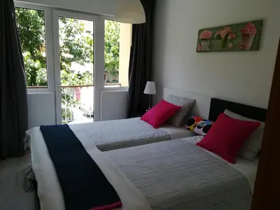 two beds in a room with two windows at Kris Apartments Porto in Porto