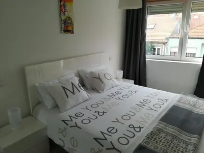 a bedroom with a white bed with the words my new home on it at Kris Apartments Porto in Porto