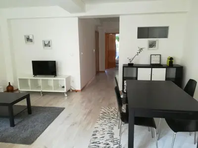 a dining room with a black table and chairs at Kris Apartments Porto in Porto