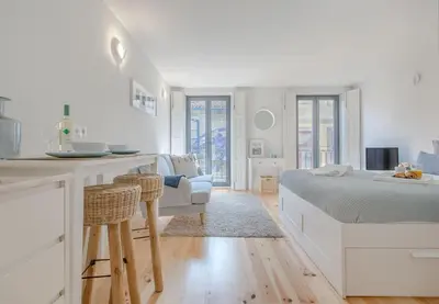 a room with a bed with blue pillows at Downtown Porto Flat, Walk to City Center in Porto