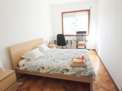 a white chair sitting on a balcony with a window at Grandmotherhouse 2-7 Pax in Porto