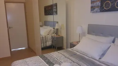 a bedroom with a bed and a mirror at Downtown Porto with PARKING next to subway in Porto