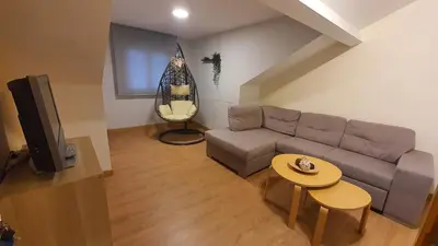a living room with a couch and a table at Downtown Porto with PARKING next to subway in Porto