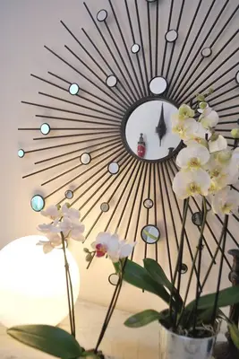 a vase with white flowers in front of a mirror at Casa Braancamp - Beautiful & Calm in Porto