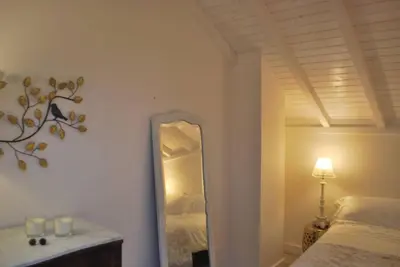 a mirror in a bedroom with a bed and a lamp at Casa Braancamp - Beautiful & Calm in Porto