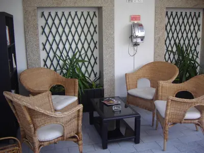 a patio with wicker chairs and a table at Hotel Grande Rio in Porto