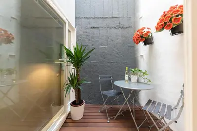 a small table and chairs on a balcony with plants at BmyGuest - Villa Lóios Terrace Apartment in Porto