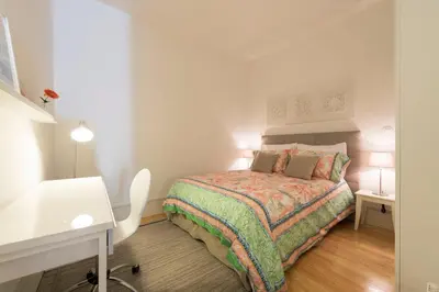 a small white bedroom with a bed and a desk at BmyGuest - Villa Lóios Terrace Apartment in Porto