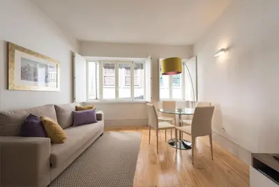 a living room with a couch and a table at BmyGuest - Villa Lóios Terrace Apartment in Porto