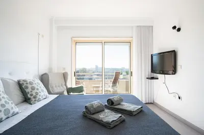 a bedroom with a bed with two towels on it at Porto Gaia River View 8 by MP in Vila Nova de Gaia