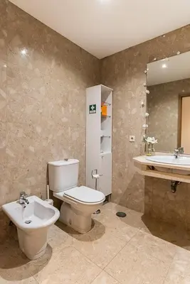 a bathroom with a toilet and a sink and a mirror at Porto Gaia River View 8 by MP in Vila Nova de Gaia
