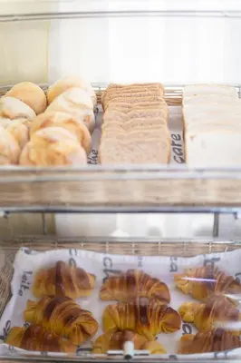 a display case with different types of bread and pastries at Hotel Universal in Porto