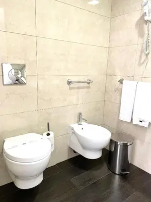 a bathroom with a toilet and a sink at Hotel Universal in Porto