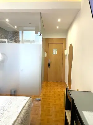 a bedroom with a bed and a wooden floor at Hotel Universal in Porto