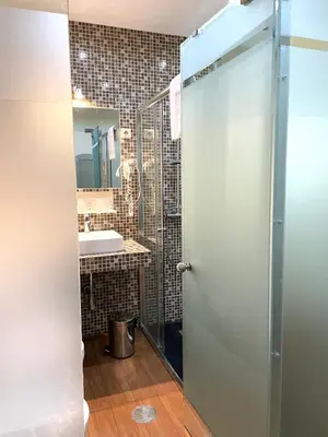 a bathroom with a shower and a sink at Hotel Universal in Porto