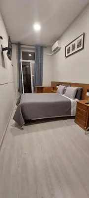 a bedroom with a large bed in a room at Residencial Sol da Nave in Porto