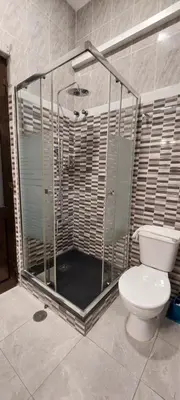 a bathroom with a shower with a toilet in it at Residencial Sol da Nave in Porto