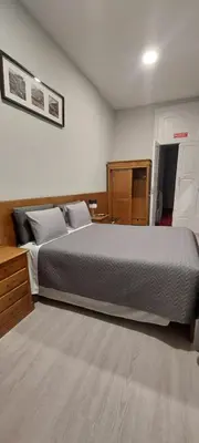 a bedroom with a large bed in a room at Residencial Sol da Nave in Porto