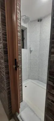 a bathroom with a white tub and a shower at Residencial Sol da Nave in Porto