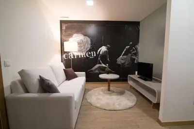a living room with a white couch and a table at Porto Coliseum Hotel in Porto