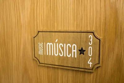 a wooden door with a sign that reads the museum at Porto Coliseum Hotel in Porto