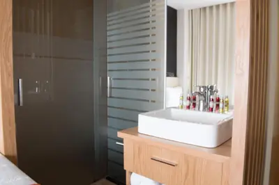 a bathroom with a sink and a shower at Porto Coliseum Hotel in Porto