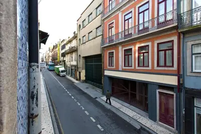 a person walking down a street next to buildings at Calm In Formosa in Porto