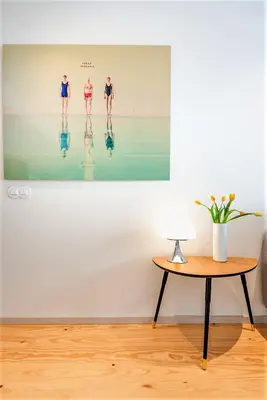 a living room with a table and a picture on the wall at Bom Jardim Apartments in Porto