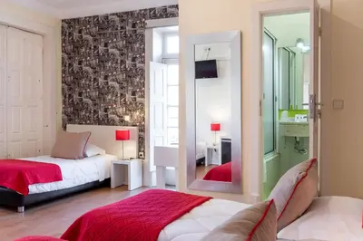 a bedroom with a bed and a mirror at Hotel do Norte in Porto