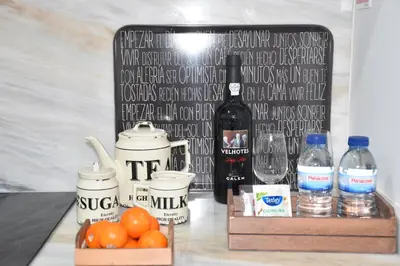 a table topped with bottles of water and oranges at Sé Boutique Apartment in Porto