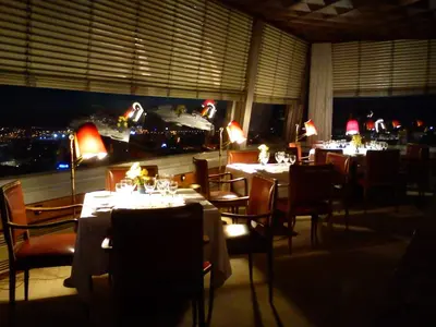 a dining room with tables and chairs with lights at Hotel Miradouro in Porto