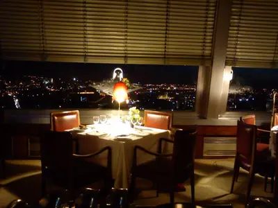 a table in a restaurant with a view of a city at Hotel Miradouro in Porto