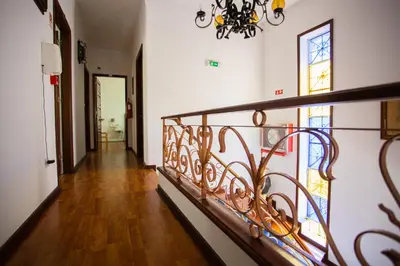 a hallway with a wrought iron railing in a house at Hotel Borsalino in Porto