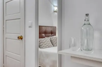 a door with a mirror in a room with a bed at Hotel Borsalino in Porto