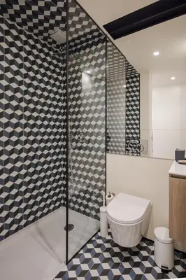a bathroom with a toilet and a glass shower at HM - Ribeira São João 2D in Porto