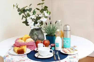 a table topped with a plate of bread and fruit at HM - Ribeira São João 3F in Porto