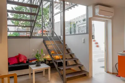 a room with a loft bed and a staircase at Peach Hostel & Suites in Porto