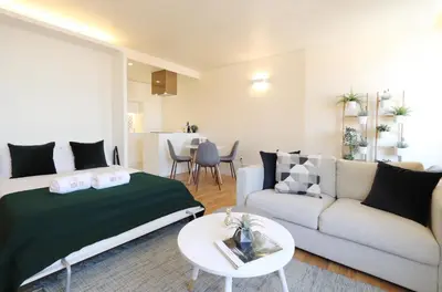 a living room with a bed and a couch at HM - Ribeira São João 5K in Porto