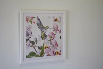 a framed picture of a bird and flowers at Casa do Avô in Porto