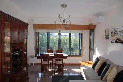 a living room with a table and a dining room at Galizia Flat in Porto