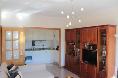 a living room with a couch and a kitchen at Galizia Flat in Porto
