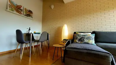 a living room with a couch and a table with chairs at Portus Vita Apartamento T0 Duplex in Vila Nova de Gaia