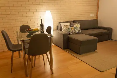a living room with a table and a couch at Portus Vita Apartamento T0 Duplex in Vila Nova de Gaia