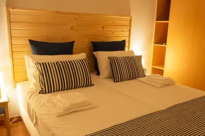 a bedroom with a large bed with two pillows at Portus Vita Apartamento T0 Duplex in Vila Nova de Gaia