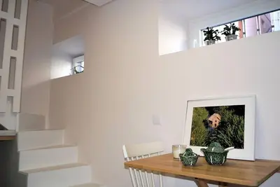a dining room with a table and a picture on the wall at Casa Braancamp II - Chic & Sweet in Porto