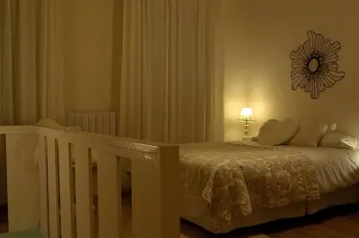 a bedroom with a bed with a mirror on the wall at Casa Braancamp II - Chic & Sweet in Porto