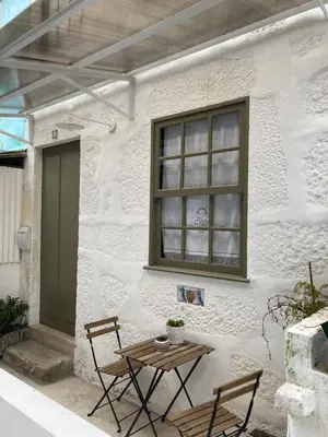 a patio with a table and chairs in front of a building at J3M Houses in Porto