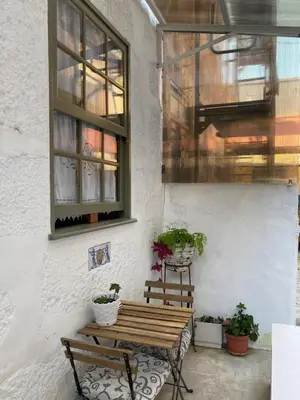 a patio with a wooden bench and potted plants at J3M Houses in Porto