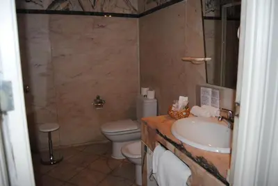 a bathroom with a shower and a bath tub at Hotel Peninsular- Porto in Porto